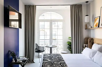 a living room with a bar with chairs and tables at Le Riviera Collection, Signature Collection by Best Western in Nice