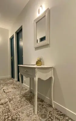 a white dressing table with a mirror on a wall at Hotel Solara in Nice