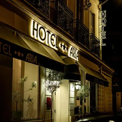 a store with a sign on the side of a building at Hotel Aria in Nice