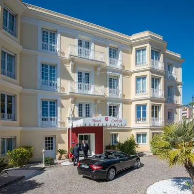 a black car parked in front of a building at Hotel Carlton in Beaulieu-sur-Mer