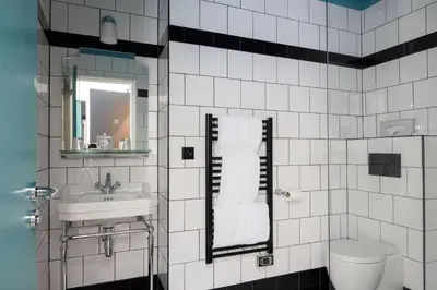 a bathroom with a sink and a toilet and a mirror at Best Western Premier Hotel Roosevelt in Nice