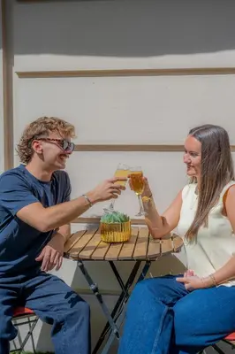 a man and woman sitting at a table with glasses of wine at Nice Excelsior Centre ville by HappyCulture in Nice