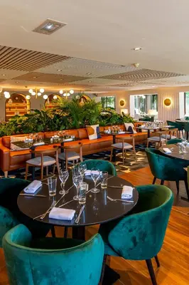 a restaurant with tables and chairs with glasses on them at Servotel Saint-Vincent in Nice