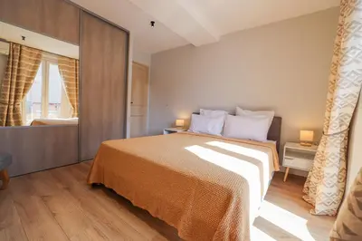 a bedroom with a bed and a large window at AzurAppart Brilliant 2room, Nice Massena in Nice