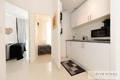 a white kitchen with a sink and a counter at Mini Suite Bijou - Five Stars Holiday House in Nice
