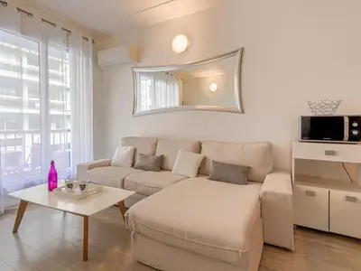a living room with a couch and a table at Apartment Le Mozart by Interhome in Nice