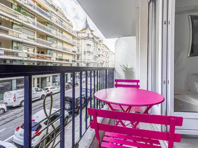 a pink table and two chairs on a balcony at Apartment Le Mozart by Interhome in Nice
