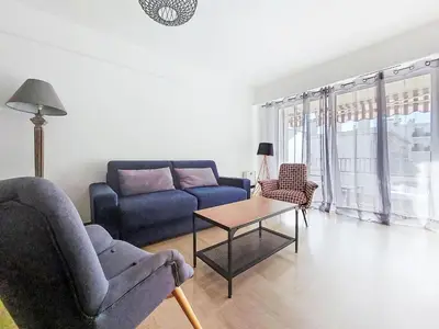 a living room with a couch and a table at Apartment Le Clos tranquille by Interhome in Nice