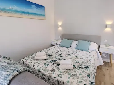 a small bedroom with a bed and a couch at Nestor&Jeeves - BLUE OCEAN - Central - Very close beaches in Nice