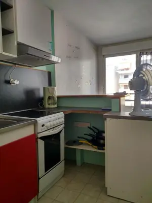 a kitchen with a stove top oven next to a window at Appartement F2 à 50 m de la plage in Nice