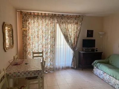 a living room with a table and a window at Palais des Arts, Proche Tram et Promenade in Nice