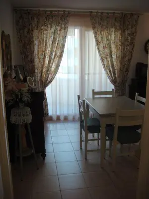 a dining room with a table and chairs and a window at Palais des Arts, Proche Tram et Promenade in Nice