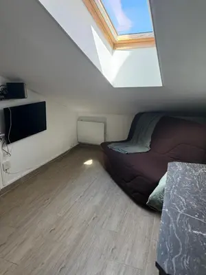 a bedroom with a bed and a flat screen tv at Mansarde à 1 min de la mer in Nice