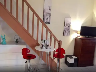 a bedroom with a bed and two chairs at Aida - rue Bosio in Nice