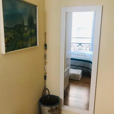 a hallway with a mirror in a room with a bed at Nice Apartment Roses & Ivy, Rue du Congres in Nice
