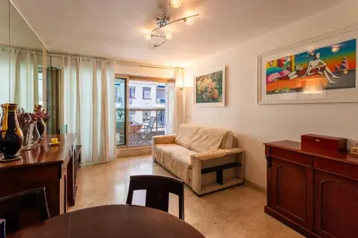 a living room with a couch and a dining room at MASSENET VIEW AP4168 Nice, by Riviera Holiday Homes in Nice