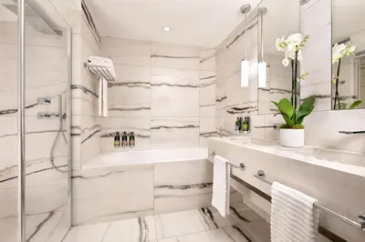 a bathroom with a shower and a tub and a sink at Le Meridien Nice in Nice