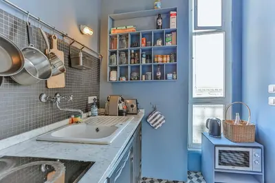 a bathroom with a sink and a blue wall at Maison Bianchi - 24 Paul Deroulede in Nice