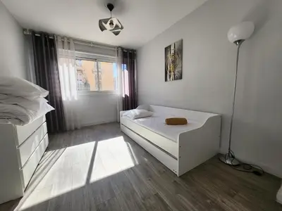 a bedroom with a white bed and a lamp at Port, vue mer et confort et parking in Nice