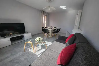 a living room with a couch and a table at Port, vue mer et confort et parking in Nice