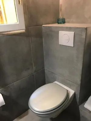 a bathroom with a white toilet and a window at STUDIO VIEILLE VILLE in Nice