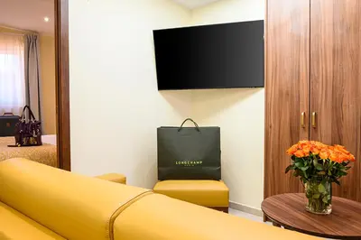 a living room with a yellow couch and a table at Résidence Aston la Scala in Nice