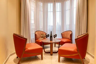 a dining room with a table and chairs and a window at Résidence Aston la Scala in Nice