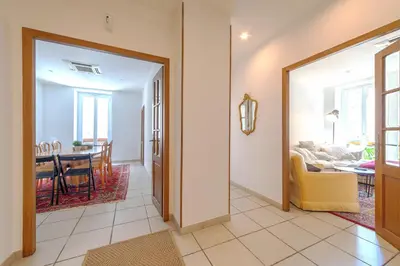 a hallway with a living room and a dining room at Lovely large familial apartment in central Nice, ten minutes walk to the beach! in Nice