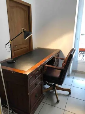 an office desk with a lamp and a chair at Lovely large familial apartment in central Nice, ten minutes walk to the beach! in Nice