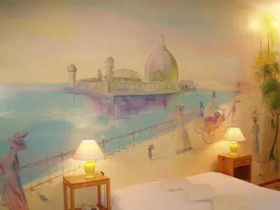 a bedroom with a mural of a beach at Le Windsor, Jungle Art Hotel in Nice