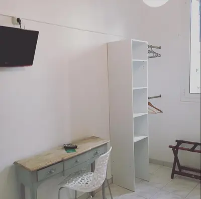 a desk and a chair in a room at Hotel Danemark in Nice