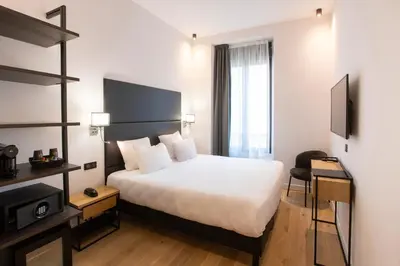 a hotel room with a bed and a television at Hotel Saint Georges in Nice