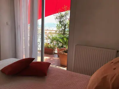 a bedroom with a bed and a large window at LOFT 360° Nice in Nice