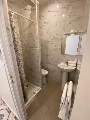 a bathroom with a shower and a toilet and a sink at Interlaken in Nice