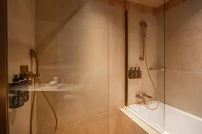 a bathroom with a shower and a sink at Hôtel Le Soleia by Inwood Hotels in Nice