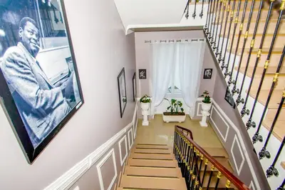 a staircase with a picture of a man on the wall at Hôtel Parisien in Nice