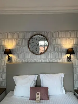 a bedroom with a bed with a mirror above it at Hotel La Villa Nice Victor Hugo in Nice