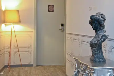 a statue sitting on a table next to a lamp at Hotel La Villa Nice Victor Hugo in Nice