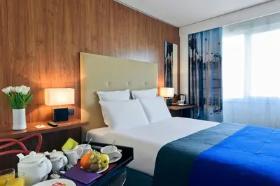 a hotel room with a bed and a table with fruit at Nice Centre Hotel in Nice