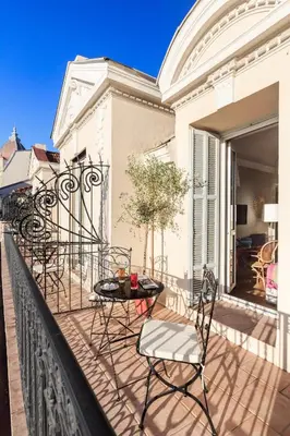 a patio with chairs and a table on a balcony at Villa Otero by Happyculture in Nice