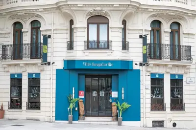 a building with a blue door in front at Villa Bougainville by Happyculture in Nice