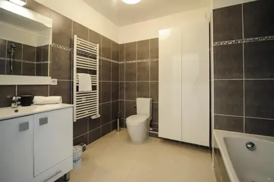 a bathroom with a toilet and a sink and a tub at Mini suite Othello - Five Stars Holiday House in Nice