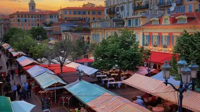 a group of tables and umbrellas on a city street at Nestor&Jeeves - LAGOON PROMENADE - Central - Sea front in Nice
