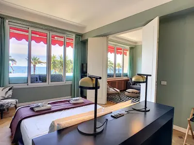 a bedroom with a bed with a view of the ocean at Nestor&Jeeves - LAGOON PROMENADE - Central - Sea front in Nice