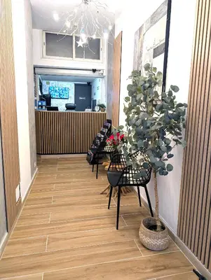 a hallway with chairs and a potted tree in a lobby at H33 Hôtel in Nice