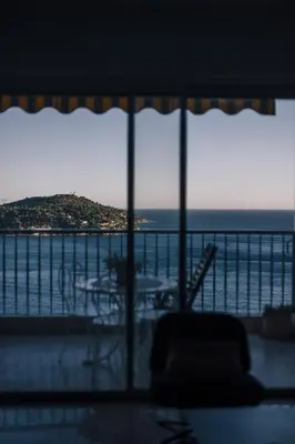 a view of the ocean from a living room window at French Riviera - 3 pièces, vue mer et piscine in Villefranche-sur-Mer