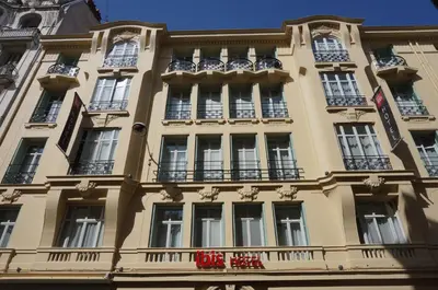 a yellow building with windows and a sign on it at ibis Nice Centre Notre Dame in Nice