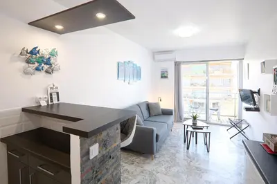 a kitchen and living room with a couch and a fireplace at STUDIO PROMENADE FLORIDA BEACH in Nice