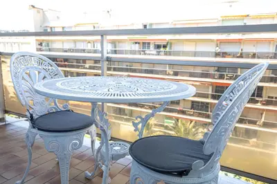 a table and two chairs sitting on a balcony at STUDIO PROMENADE FLORIDA BEACH in Nice