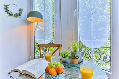 a table with fruit and a book and a window at MY CASA - GROSSO 14 - 5 min walk to beach in Nice